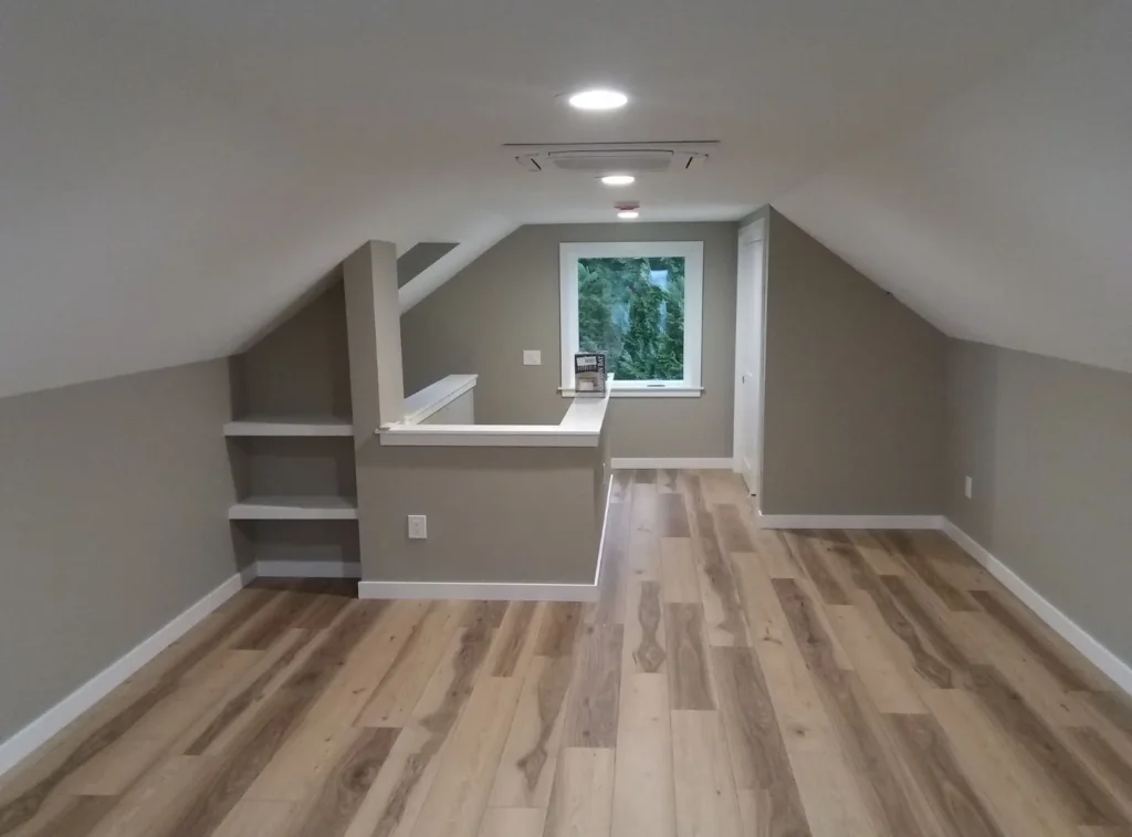 Cozy attic space with wooden flooring.