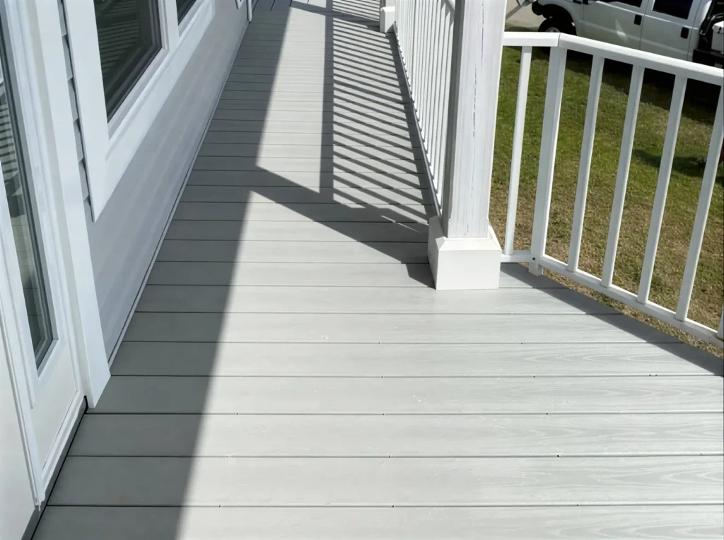 Clean, gray deck with shadows.