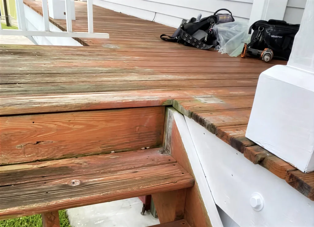 Worn wooden deck with visible damage.
